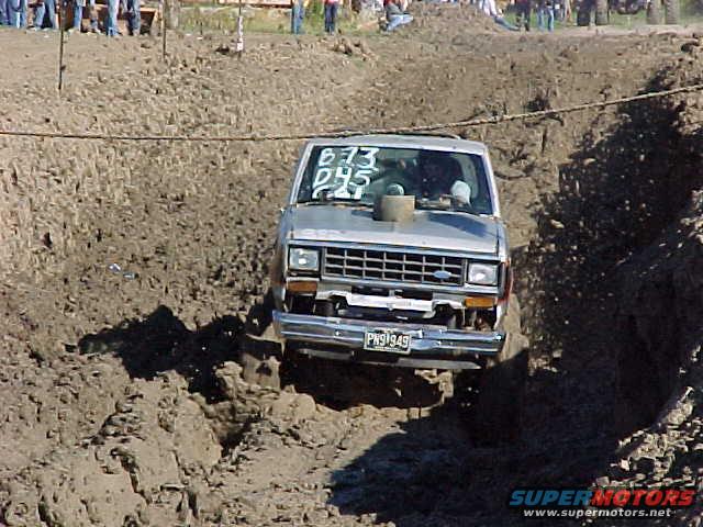 1987 Ford Ranger driving through a mud pit with "673 PHS 949" written on windshield