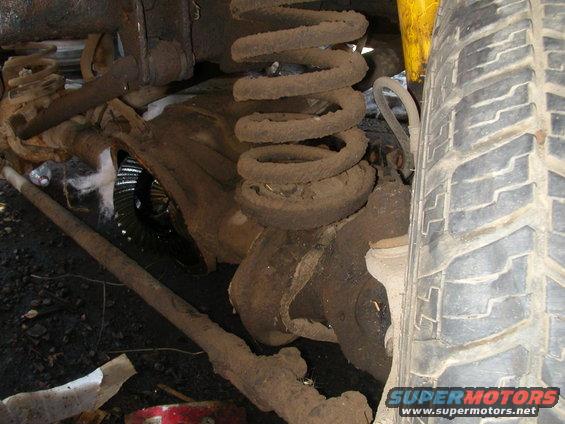 Front axle with coil spring, shock absorber, and tire visible