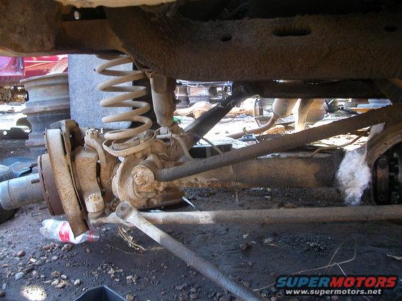 Front axle assembly with coil spring and shock absorber