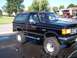 1989 Ford Bronco - This black 1989 Ford Bronco features BFGoodrich All-Terrain T/A tires and chrome side steps, parked after a wash.