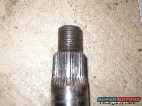 Close-up of a metal shaft with splines and threaded end