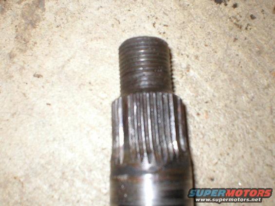 Close-up of a metal shaft with splines and a threaded end