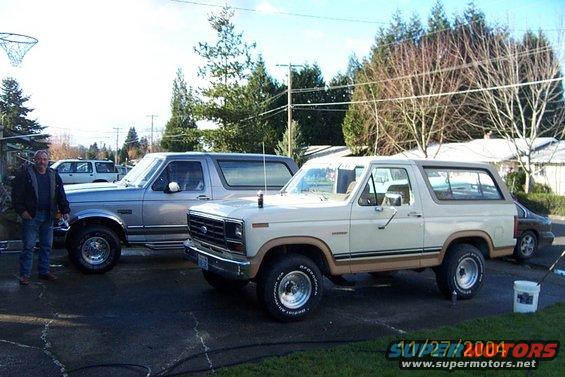Tan 1980 Ford Bronco parked next to a silver Bronco