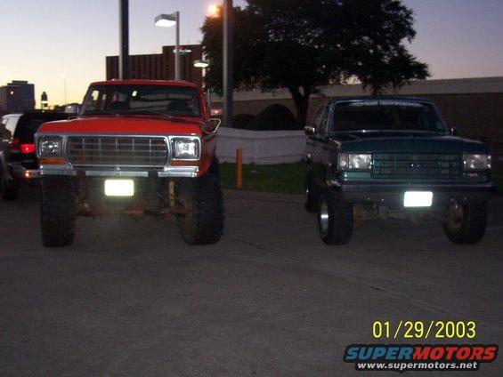 Green SUV with lifted suspension and large tires, front view