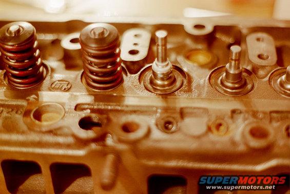 Close-up of an engine cylinder head showing valve springs and stems