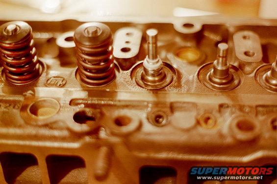 close up of engine cylinder head with valves and springs
