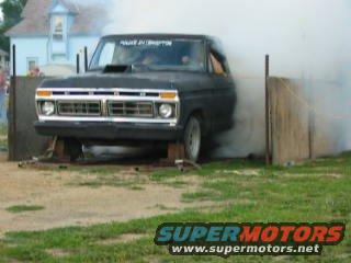 1977 Ford F-150 truck with smoke coming from under the hood, front view