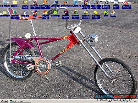 Purple and red chopper bicycle with chrome handlebars and a single headlight