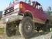 1989 Ford Bronco - This lifted 1989 Ford Bronco is shown in a three-quarter front view, highlighting its off-road capabilities.