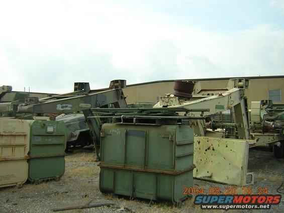 Military equipment and storage containers in a yard