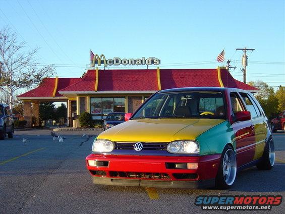 Multi-colored Volkswagen Golf Mk3, front view, parked in front of a McDonald's