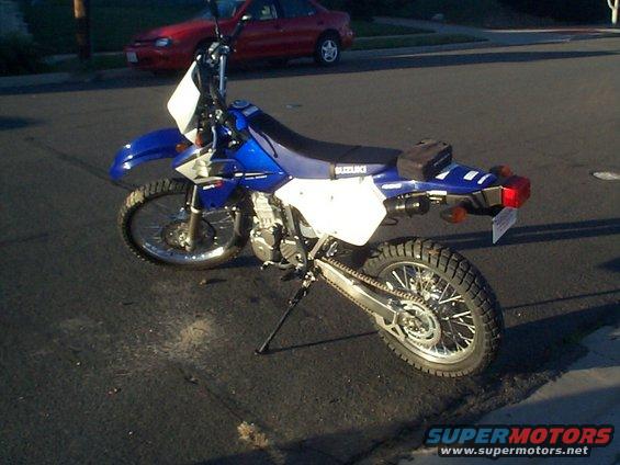 2005 Suzuki DR-Z400S dual-sport motorcycle parked on asphalt, side view. Suzuki logo visible on seat