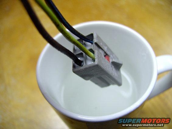 img_0200.jpg Recognize this plug ? It's the notorious plug that rots out and leaves you with no map lights or cargo light , no matter how often you change the bulbs and fuse. I scored this mildly corroded plug from a wreck.  I'm dipping it in baking soda and warm water to etch all the green corrosion off it's connectors before I solder it into my harness because mine was rotted away. BTW it's located behind your left kick panel.