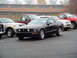 1979 Ford Bronco - A black 2005 Ford Mustang GT is parked in a lot with other vehicles.