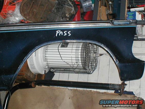Dark blue fender with 'PASS' written on it, fan visible behind wheel well