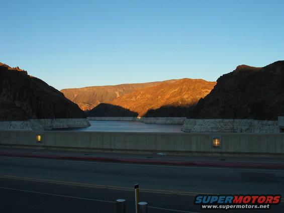 Hoover Dam and Lake Mead at sunrise with mountains in the background