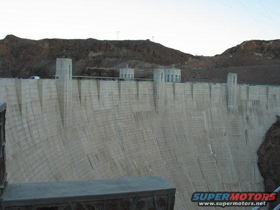 Hoover Dam with mountains in background and a white van on top