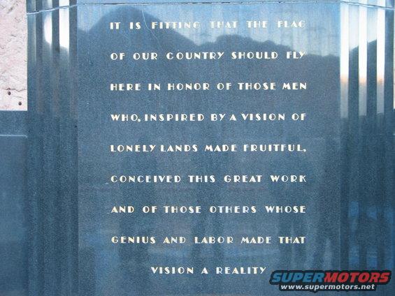 Stone monument with engraved text about the flag and country