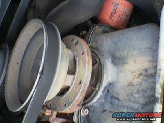 engine pulley with a belt and a FRAM oil filter