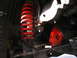 1994 Ford Bronco - Undercarriage view showing a red coil spring and suspension components.