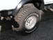 1994 Ford Bronco - Close-up of a BFGoodrich Mud-Terrain T/A tire and chrome wheel, with a visible exhaust pipe.