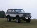 1994 Ford Bronco - This 1994 Ford Bronco features a two-tone paint scheme and an aggressive aftermarket bumper with auxiliary lights.