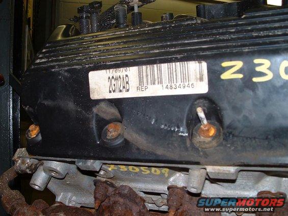 Black engine valve cover with a white label showing "2G112AB" and "14834946"