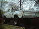 1979 Ford F-150 - This heavily damaged 1979 Ford F-150 pickup truck is seen from the rear while on a trailer.