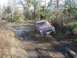 1988 Ford Bronco - This Jeep Cherokee XJ is navigating a muddy off-road trail with water obstacles.