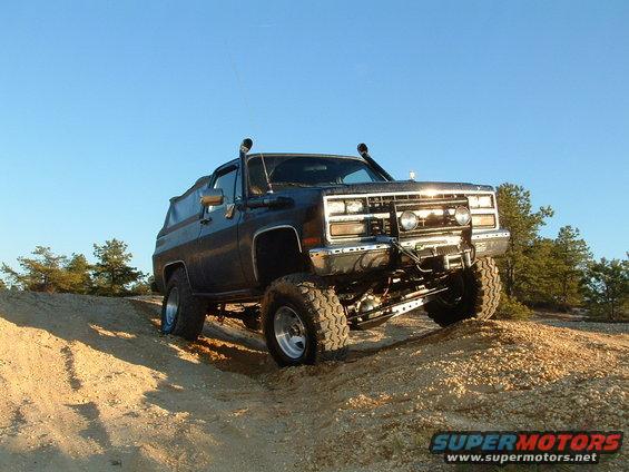 1989 Chevrolet Blazer climbing dirt hill, snorkel, off-road tires