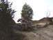 1992 Ford Bronco - An off-road vehicle navigates a challenging, steep, and rocky terrain under a bright sky.