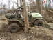1992 Ford Bronco - Modified Jeep Wrangler navigating difficult off-road terrain with another vehicle visible behind it.