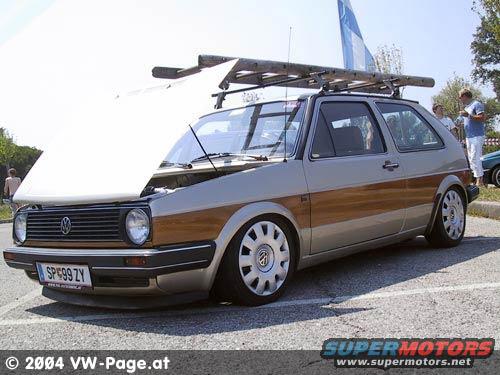 Silver Volkswagen Golf with wood paneling and roof rack, license plate SP99 ZY