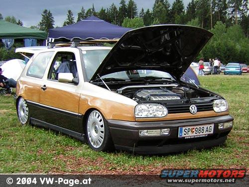 Volkswagen Golf Mk3 with wood paneling, hood open, showing engine. License plate SP 988 AG