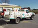 1973 Ford F-250 - This 1973 Ford F-250 service truck, marked "SQUAD 111", features a white body with distinctive green trim and utility compartments.