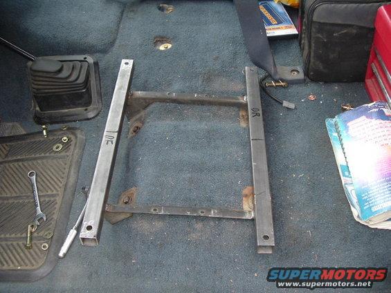 dscf0590.jpg pretty simple brackets i made using 1-1/8" square tube and the brackets that rivet to the factory sliders. the saab sliders are about the same length, but about 2" wider on either side. the square tube made the sitting position just a tad higher than stock which is nice because i'm really not that tall.  