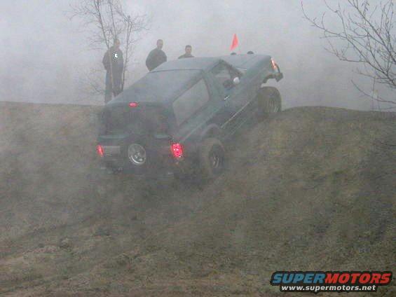 Dark green 1979 Ford Bronco climbing a dirt hill