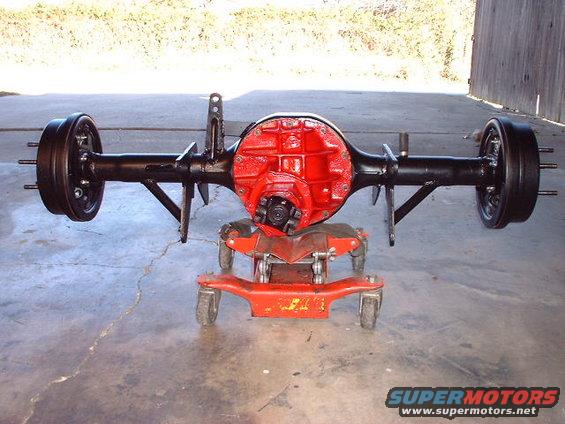 Rear axle assembly with red differential housing and drum brakes