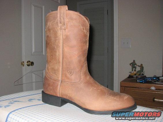 brown leather cowboy boot with stitching detail and a small logo on the side