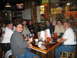 2002 Ford Taurus - Friends enjoy drinks and conversation at a table in a rustic bar setting.