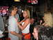 2002 Ford Taurus - A woman in a Hooters uniform signs a man's t-shirt while people gather around in a bar.