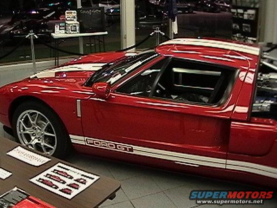 Red Ford GT with white stripes and "FORD GT" text on the side