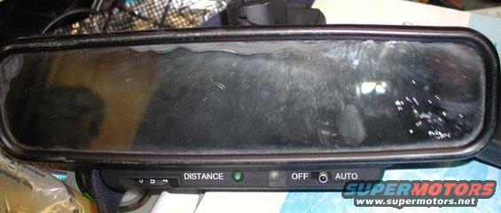Rearview mirror with "DISTANCE" and "AUTO" labels, and a green indicator light
