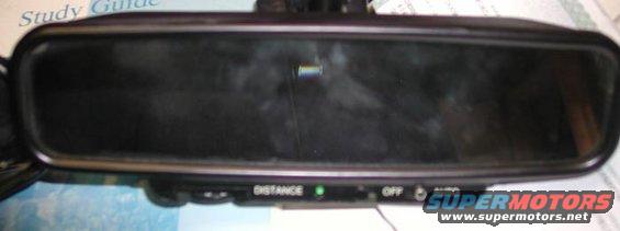 Auto-dimming rearview mirror with 'DISTANCE', 'OFF', and 'AUTO' labels