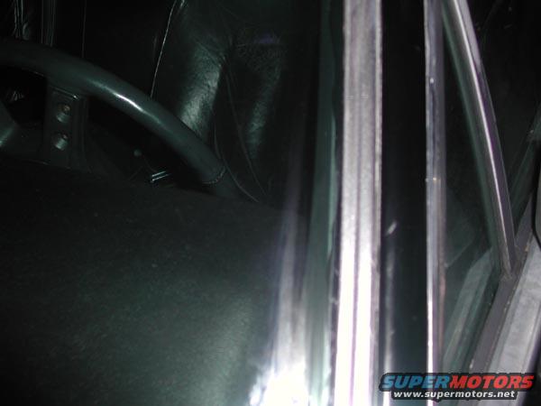 Dark car interior with leather seats and steering wheel visible. A "SUPERMOTORS" watermark is present