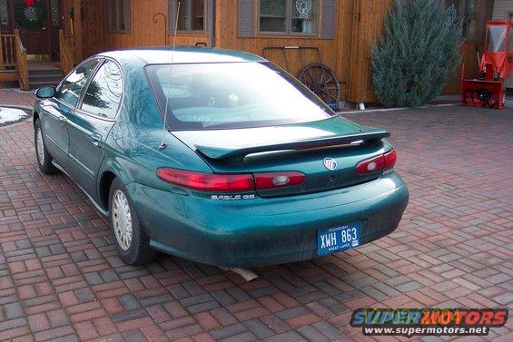 Rear view of a green 1996 Mercury Sable with a spoiler and a Michigan license plate