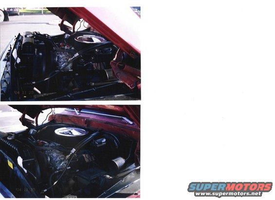 engine bay with hood open, showing engine components and radiator