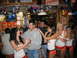 2002 Ford Taurus - People are gathered at a Hooters restaurant, with servers interacting with patrons.