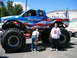 2002 Ford Taurus - A Bigfoot monster truck, painted with a patriotic theme, is shown with two people standing nearby. The registry claims it is a 2002 Ford Ta…