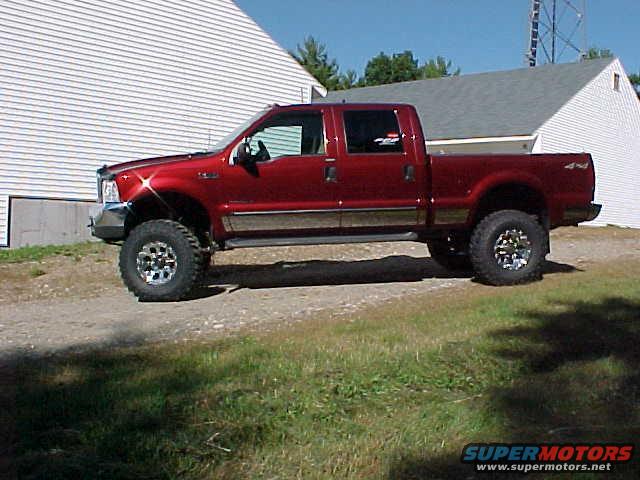Red 2000 Ford F-250 crew cab pickup truck, side view